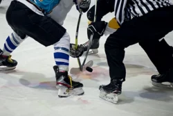Ice hockey players play ice hockey