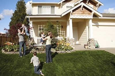 family in front of house